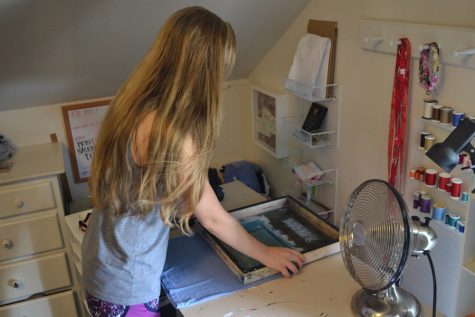 Kate prints a T-shirt using a screen technique to apply her design to the shirt's fabric, leaving it with a clean, polished look. All of her shirts are printed by hand with close attention to detail in the comfort of her bedroom.