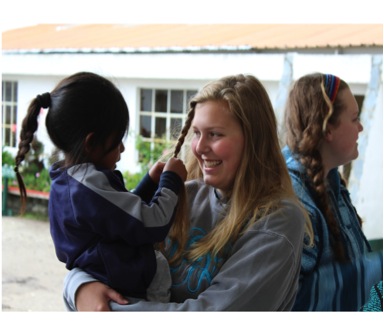 Junior Lauren Berry enjoys getting to know a young girl after a long day of aiding in dental work.