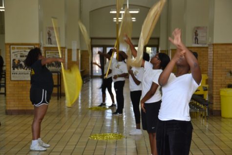 Flag Line shows off their moves during practice in the cafeteria.