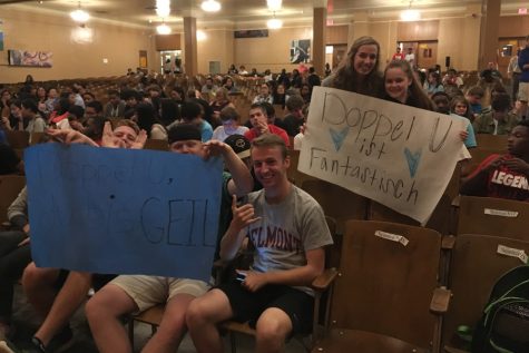 (Left to right) Seniors Collier Byrd, Jack Curtis and Jack Gardner, along with juniors Molly English and Julia Greer, hold up signs they made to support rapper Doppel-U during the talent portion of the event.
