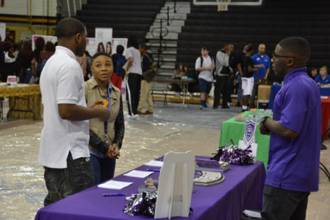 Seniors Terryl Humphrey and Daiuna Shields converse with a recruiter from the University of Central Arkansas.