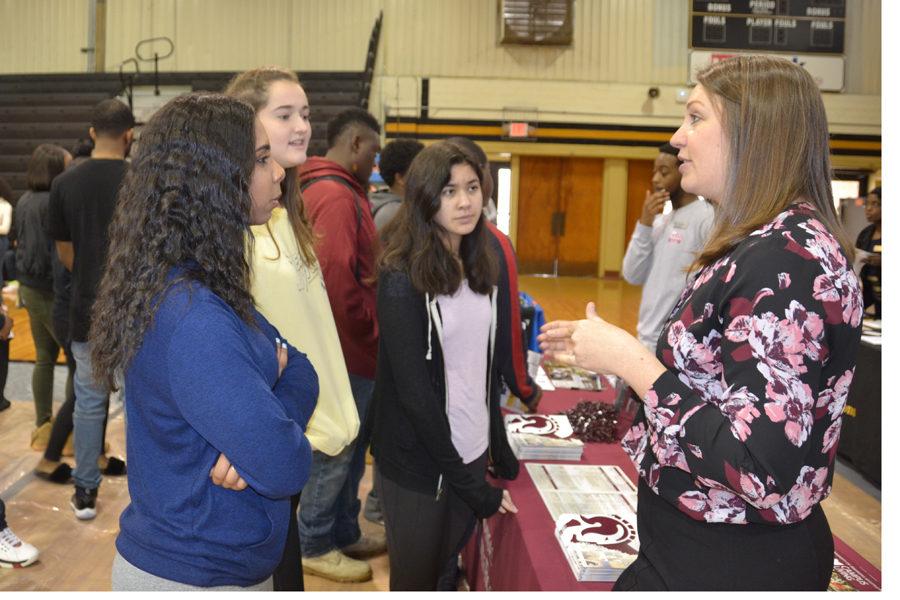 Juniors Snow Perrin, Joy Trice and Rachel Marcks listen as a recruiter from the University of Arkansas at Little Rock tells them about the school.