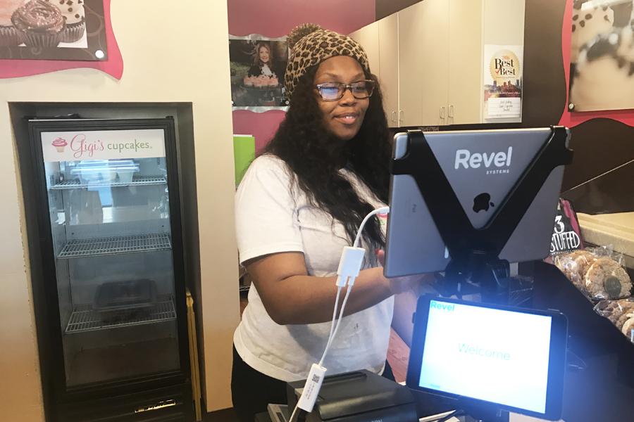 Senior Kennedi Lawson sports her company t-shirt while waiting on more hungry customers to come through the door at Gigi's Cupcakes.