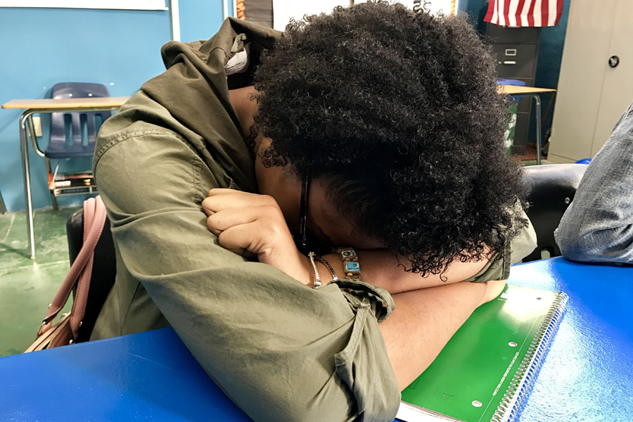 Senior Taylor Lovelace catches a few Z's on her desk after a long night of work.