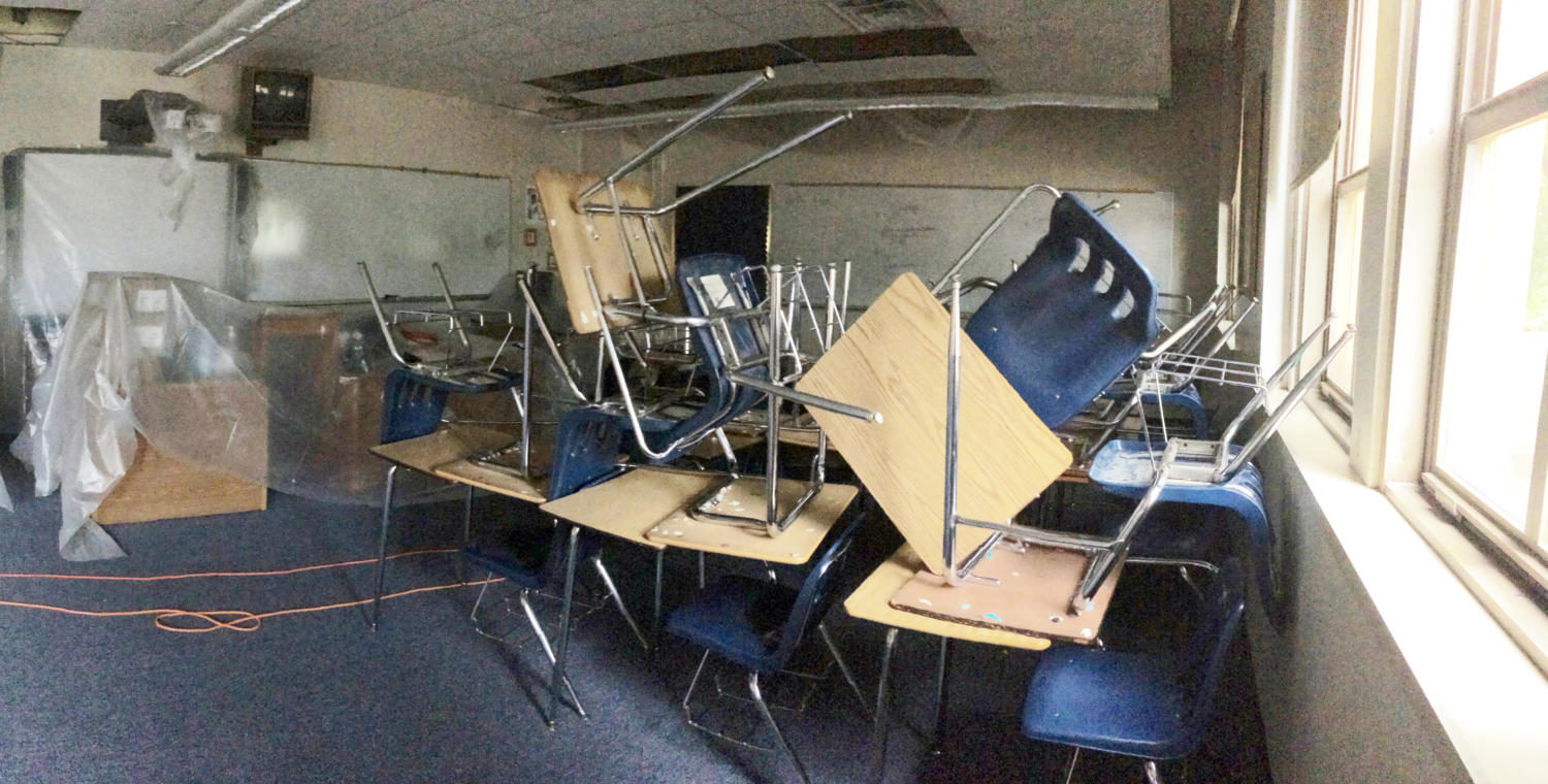 Misplaced desks, damp floors, and skewed plastic tarps are clear results of the damages visible in AP Psychology teacher Stanley Pryor’s room (photo courtesy of Stanley Pryor).