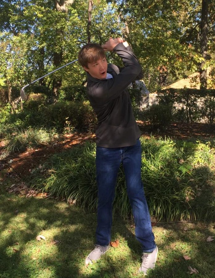 Senior Trey Berry practices his swing at home in preparation for the State Golf Tournament. (Photo by Henry Fendley)