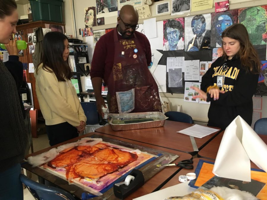 During his AP 2D Design class, Deloney shows his students new, creative ways to create unique compositions for their AP Portfolios. (photo by Sydney Gastman)
