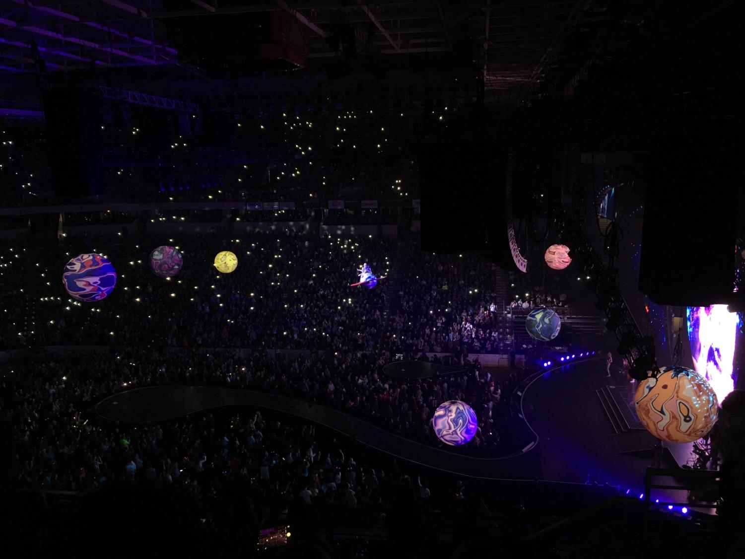 Sitting atop a Saturn-like planet that dangled from the ceiling, Perry sang a softer, melodic rendition of “Wide Awake.” It was a nice contrast to the fast paced, sensory overload that was the majority of her concert. She moved across the arena among shining flashlights waving in the audience. (photo by Sydney Gastman)