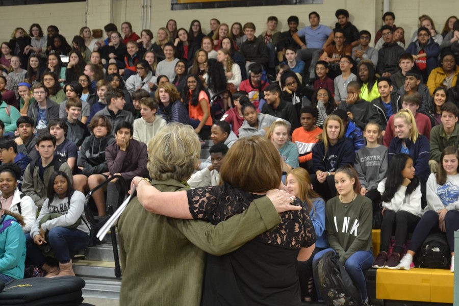 Principal Nancy Rousseau and Biology Teacher Melissa Donham embrace in front of Science Fair participants, who are eager to win their awards. (Photo by Fran Delacey)