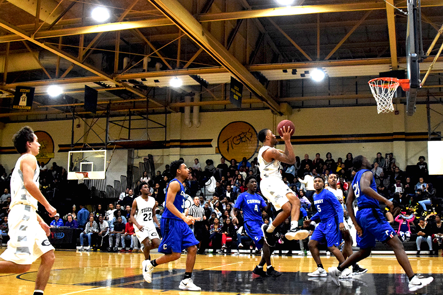 Caption: Senior Donald Richardson drives in for a lay up in the homecoming game against Conway High School where they won 54 to 63. (Photo by Gage Maris)