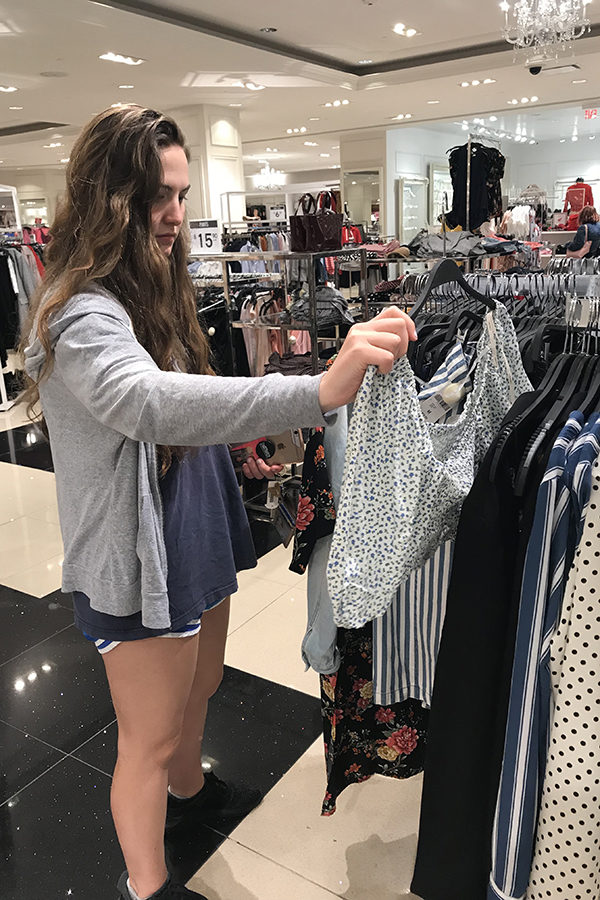 Junior Hayden Wickliffe looks at clothes at Forever 21, a store known for having a lot of options and a lot of clothes. (Photo by Emily Low)