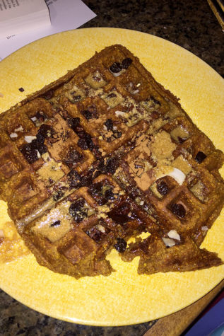 This waffle, topped with coconut flakes, cacao nibs, raisins, and peanut butter mixed with pure maple syrup, is sure to satisfy your sweet fall cravings. (photo by Sydney Gastman)