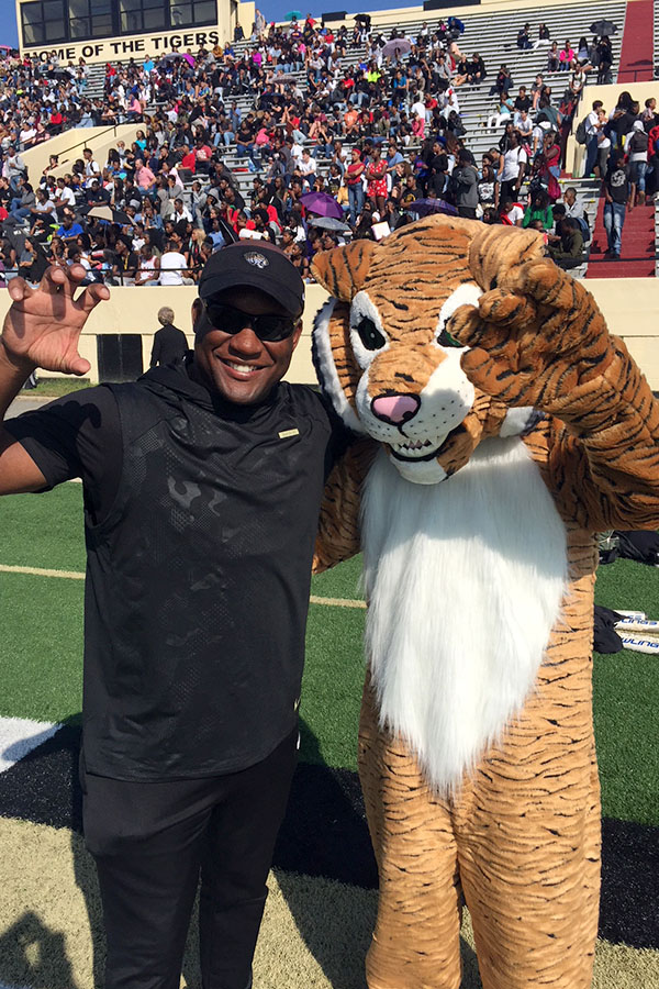 New head football coach Kent Laster and junior mascot Adam Zornes hype up the student section at the pep rally at Quigley stadium on Sep.28. (photo courtesy of Earnest Mcgee)