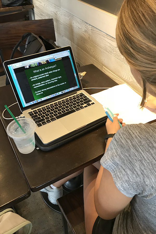 Sophomore Clare Enderlin works on homework using her own laptop, instead of the tablets given to freshmen last year from the school. (photo by Annie Fortune)
