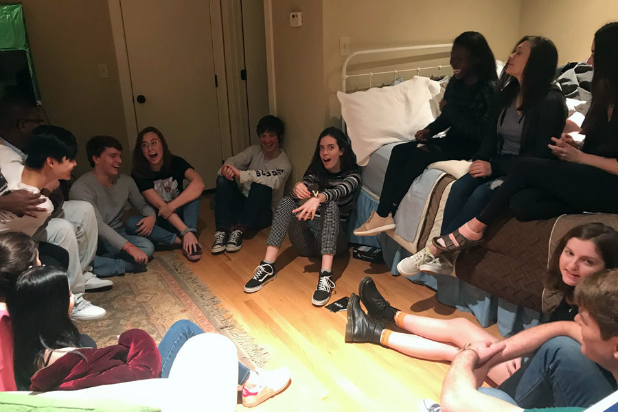 A group of friends gather for a board-game night at a home. Playing card games and hanging out is an entertaining way to spend time without spending big bucks. (photo by Lola Simmons)