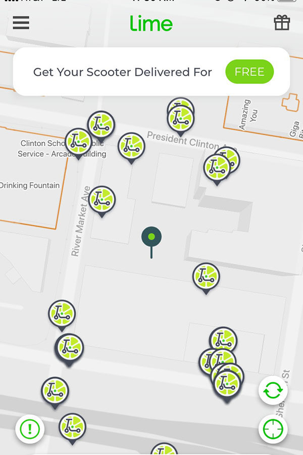 Using the Lime Scooter app, a number of scooters can be located nearby your location. Dozens of scooters can be seen in downtown Little Rock in the River Market. (photo by Lola Simmons) 
