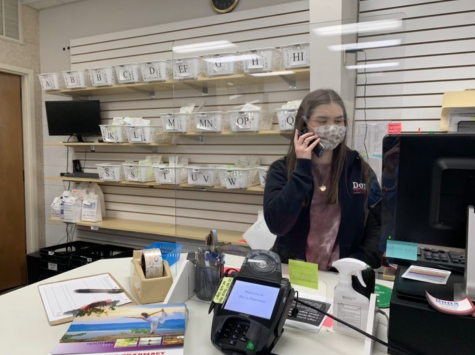 Olivia Hayden answers a call from a customer at Dons Pharmacy in Little Rock.