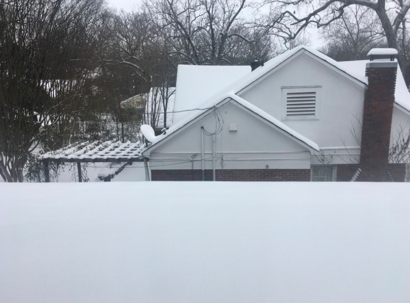 The neighborhood on Lafayette Avenue is unusually quiet under the weight of several inches of powder snow. “Staying in with hot chocolate is my favorite part of snow days,” junior Penn Hicks said.
