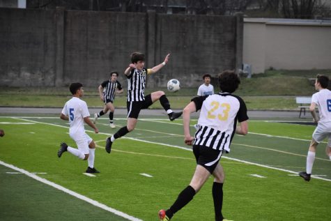 Senior Jonathan Coulter jumps to defend the ball. Coulter was the team captain for the game. Photo by Anna Yates