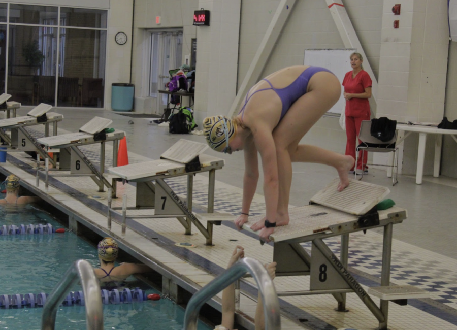 Junior Lily Keyes gets ready to dive into the pool during practice in preparation for the upcoming season.