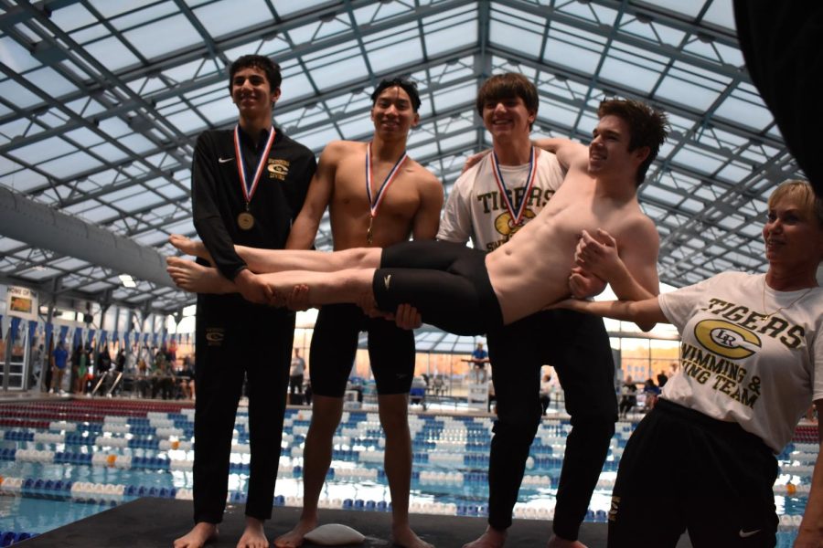Yassin Bahgat, Matthew Nguyen, Quinn Moore, and Noah Cannon pose with medals from the 500yd freestyle. They placed first through fourth, and went 9-0 this season. 