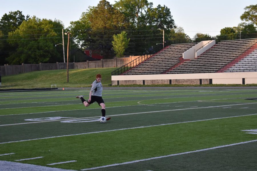 Senior captain Caden Cannon strikes the ball on a free kick against Cabot April 24. Senior year means its the last season for a lot of their players, and that makes it bittersweet for us. Last year we made state for the first time in several years so theres a big push for us to go bacl-to-back! Cannon said.