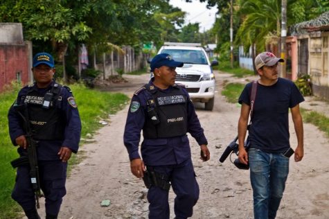 Filmmaker Brent Renaud is escorted by Honduran police while filming a documentary about young refugees for The New York Times. 