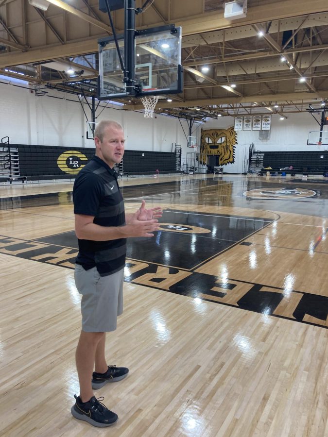 Proud leader. Head boys basketball coach Brian Ross shows off the remodeled gym. Its the coolest basketball court Ive ever seen.