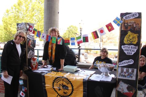 Principal Nancy Rousseau visits teachers from the foreign language department who set up a booth for the International Studies program. 