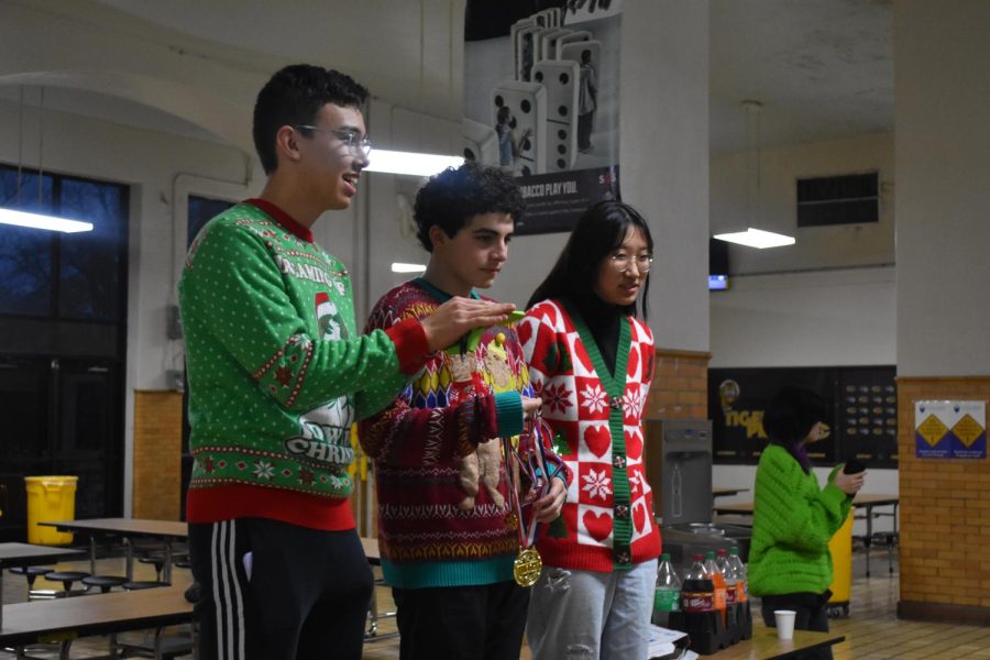 President+Thomas+Lu%2C+Senior+Representative+Abe+Wardlaw%2C+and+Vice+President+Ann+Zahn+present+medals+to+the+winners+of+the+club%E2%80%99s+ugly+sweater+contest.+%E2%80%9CWe+had+a+first%2C+a+second%2C+and+a+third+place%2C+all+with+prizes.+It+made+me+feel+really+good+to+award+those+prizes%2C%E2%80%9D+Wardlaw+said.