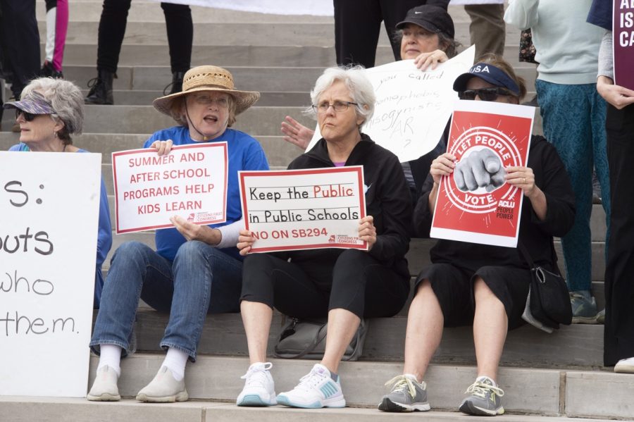 Citizens sit on the Capitol steps while protesting SB294 (Photo by Brian Chilson)