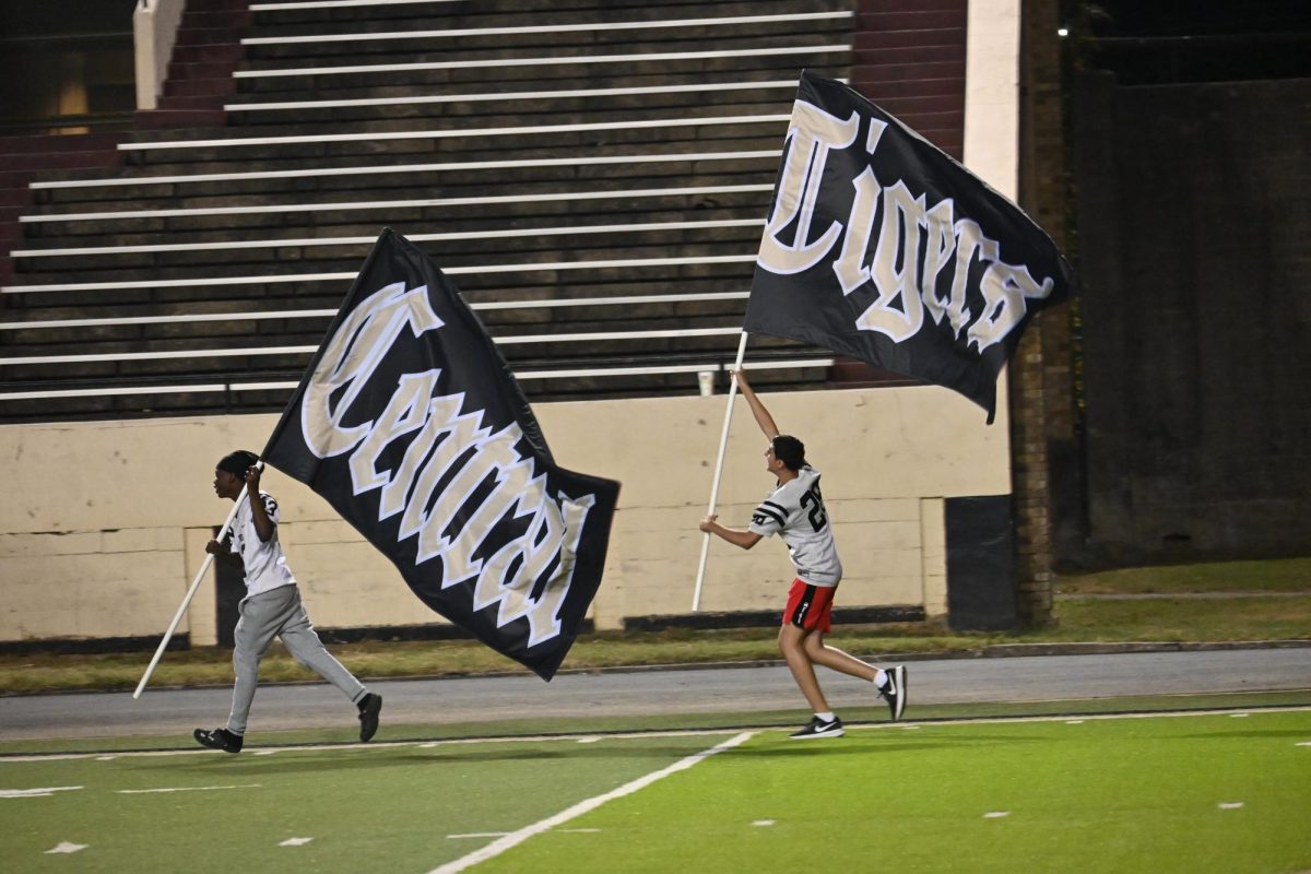 Junior Varsity football players run flags during halftime.