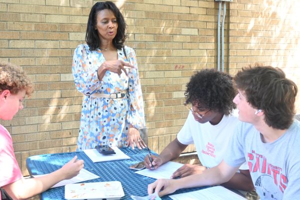 Representative Joy Springer explains the voter registration form to seniors, Chris Caldwell and Mason Chaidez, during lunch Sept. 6. 
