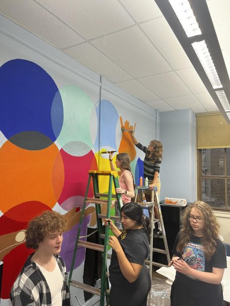 Students  Robert Fullen, Asha Carter, Lucy Paul, Kayla Jimenez, and Zachary Fullen paint the mural after school Aug. 23. 