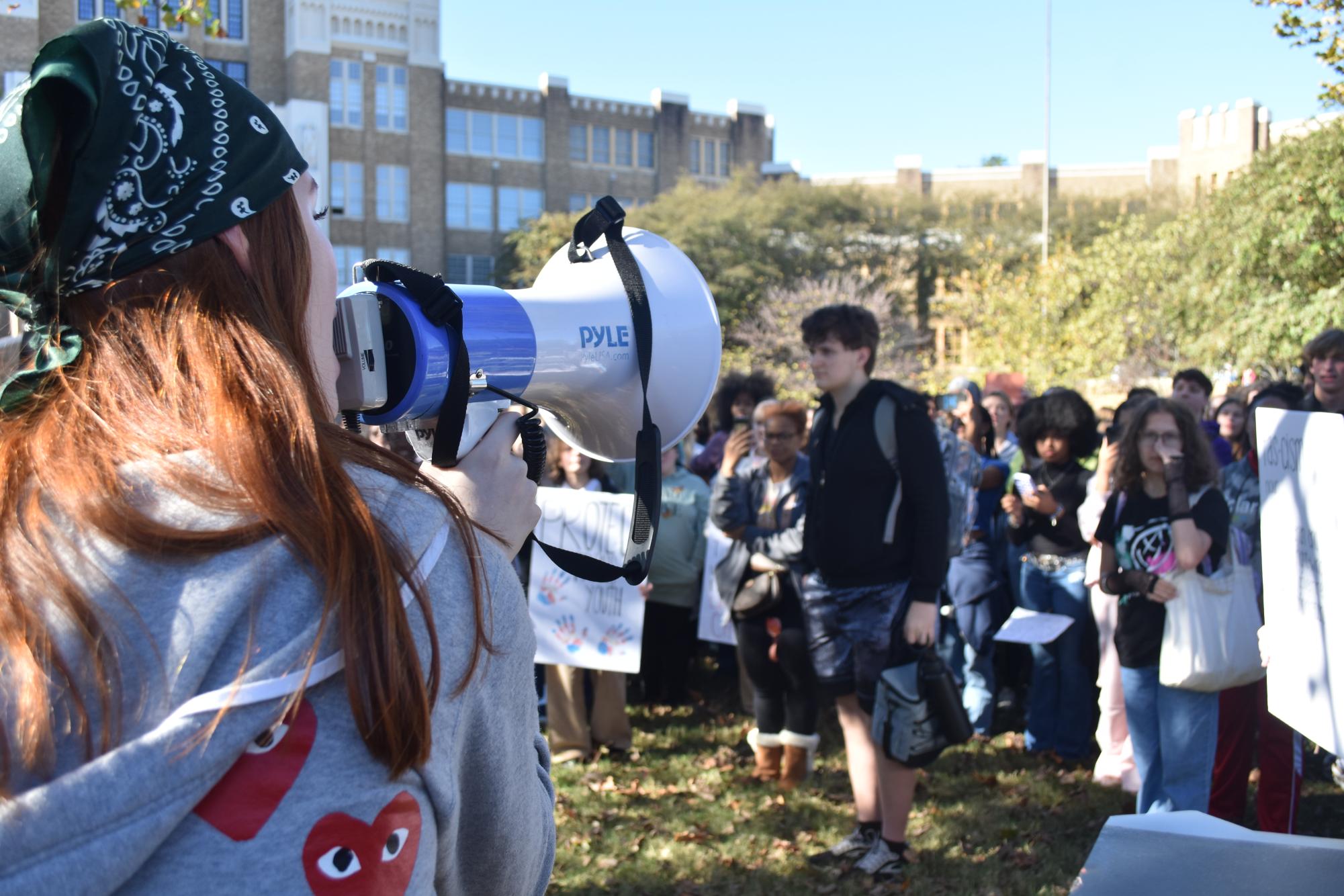 Senior Addysin Cain uses a megaphone to speak to the crowd. 