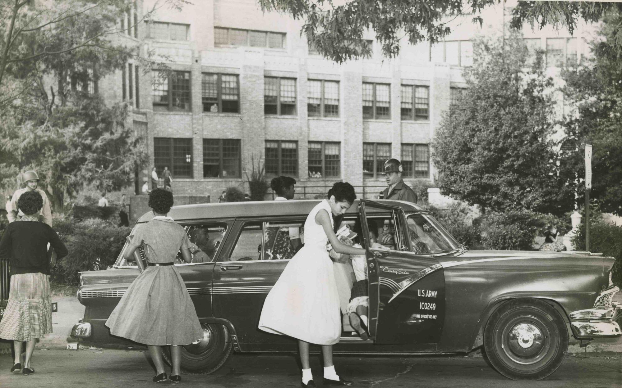 Little Rock Nine Integration Members of the Little Rock Nine arrive at Central High under federal troop escort, October 1957. Photo from  Central High School National Historic site and UALR Archives