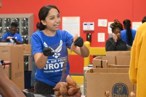 Luis Valverde weighs potatoes with JROTC as they volunteer at the Arkansas Food Bank Nov. 6.
