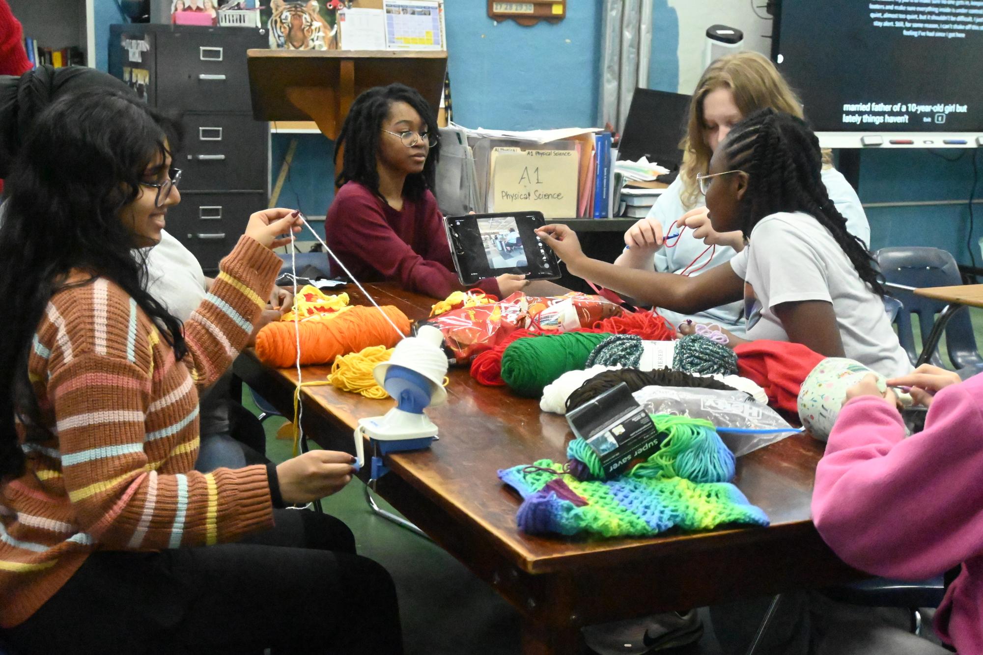 President of Yarn Club, Shalini Patil winds donated yarn to be used for crocheting while other members Taylor Crawford, Carmen Gillam, and Ayannah Prince join together and start crocheting.
