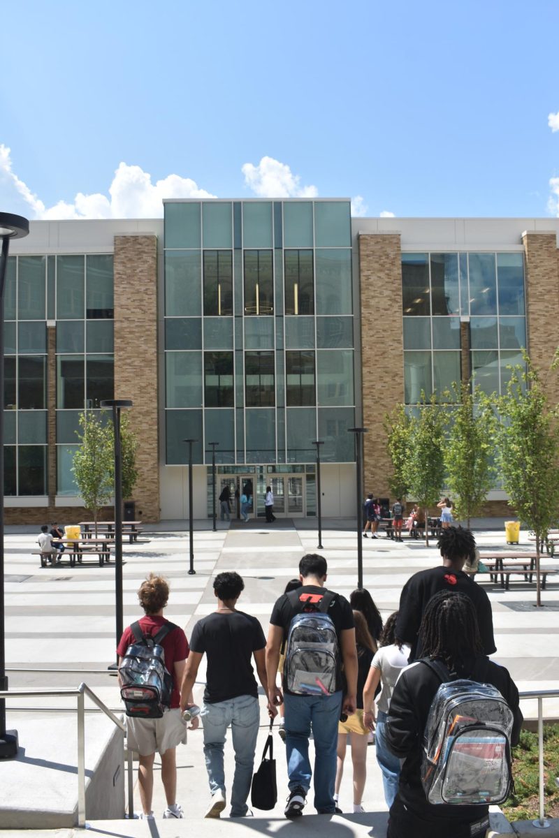 Crossing the new senior patio, students make their way to their classes in the finished science building on the second day of school.