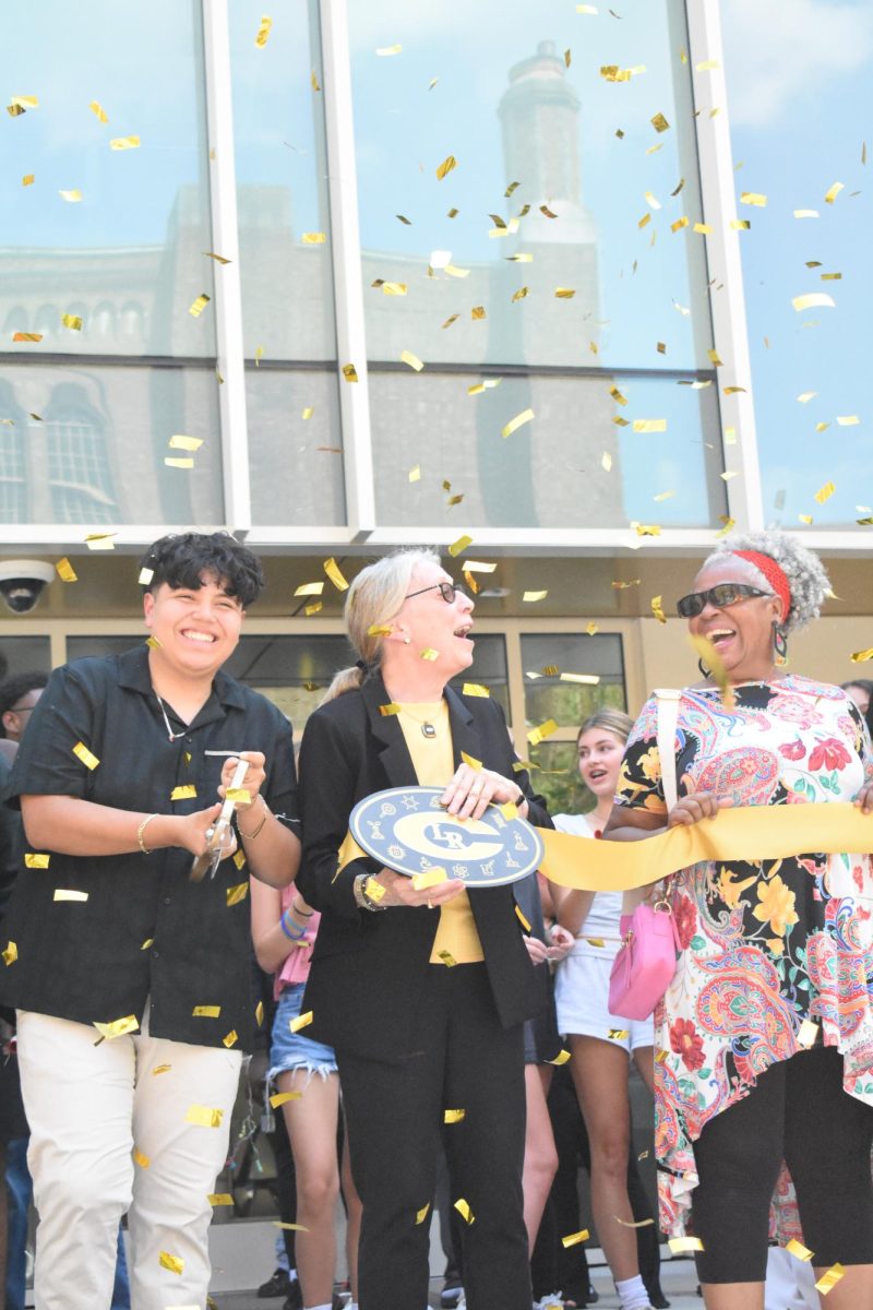 As confetti falls, Student Body President Daniel Carrillo, Principal Nancy Rousseau, and School Board Secretary Norma Johnson celebrate.