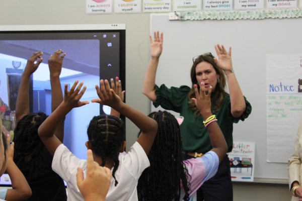 Governor Sarah Huckabee Sanders calls the hogs with third graders after visiting with them about her job as governor Aug. 12. 
