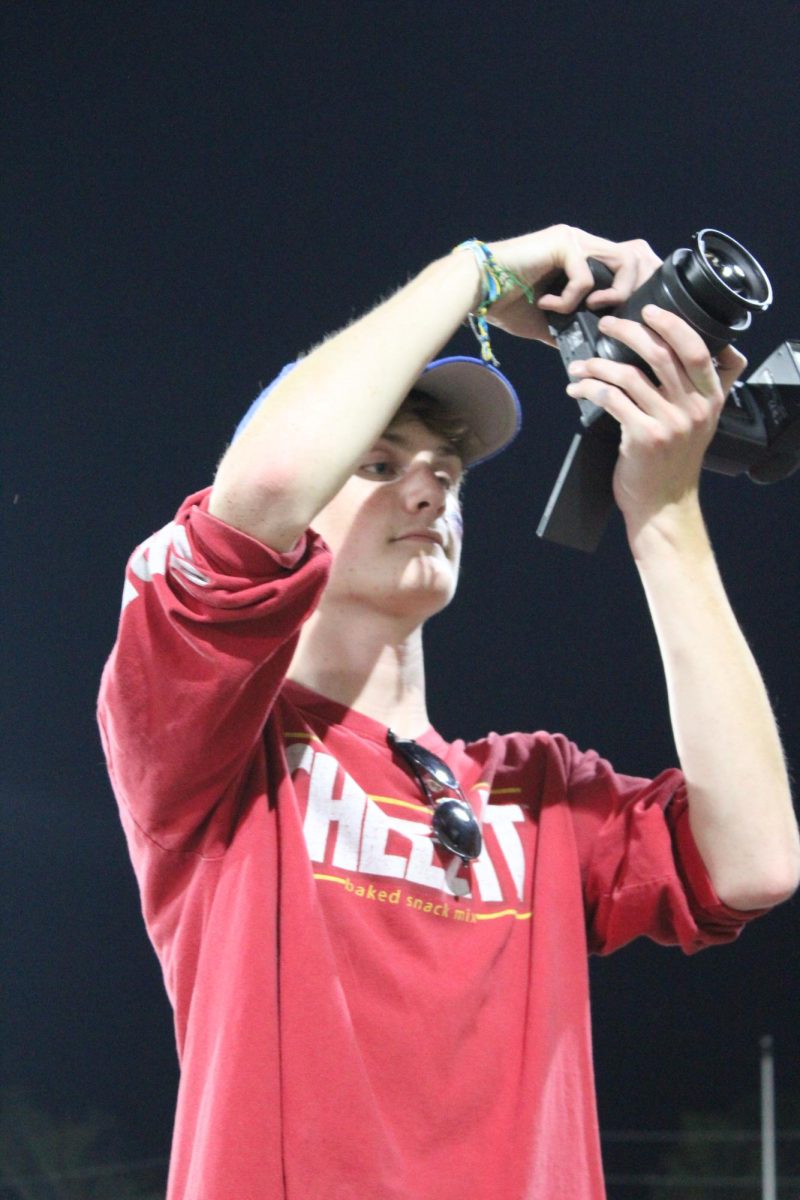 Aug. 12, at the football game against Southside, Senior Miles Navin photographs the student section, decked out in USA apparel. 