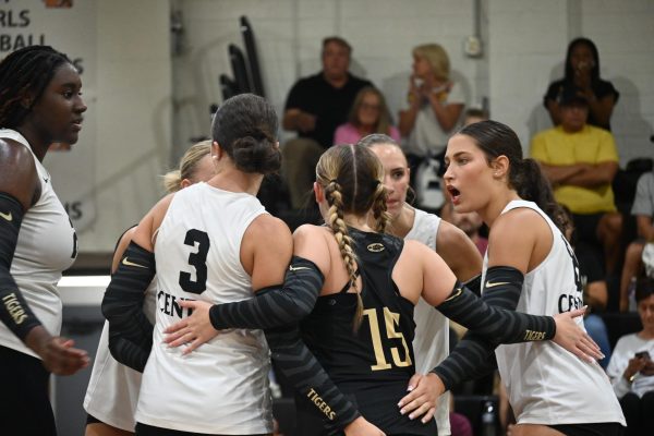Captain Lydia Warrior (senior) gives a quick pep talk to the rest of her team on court after a set they played against Greenbriar Aug. 25.