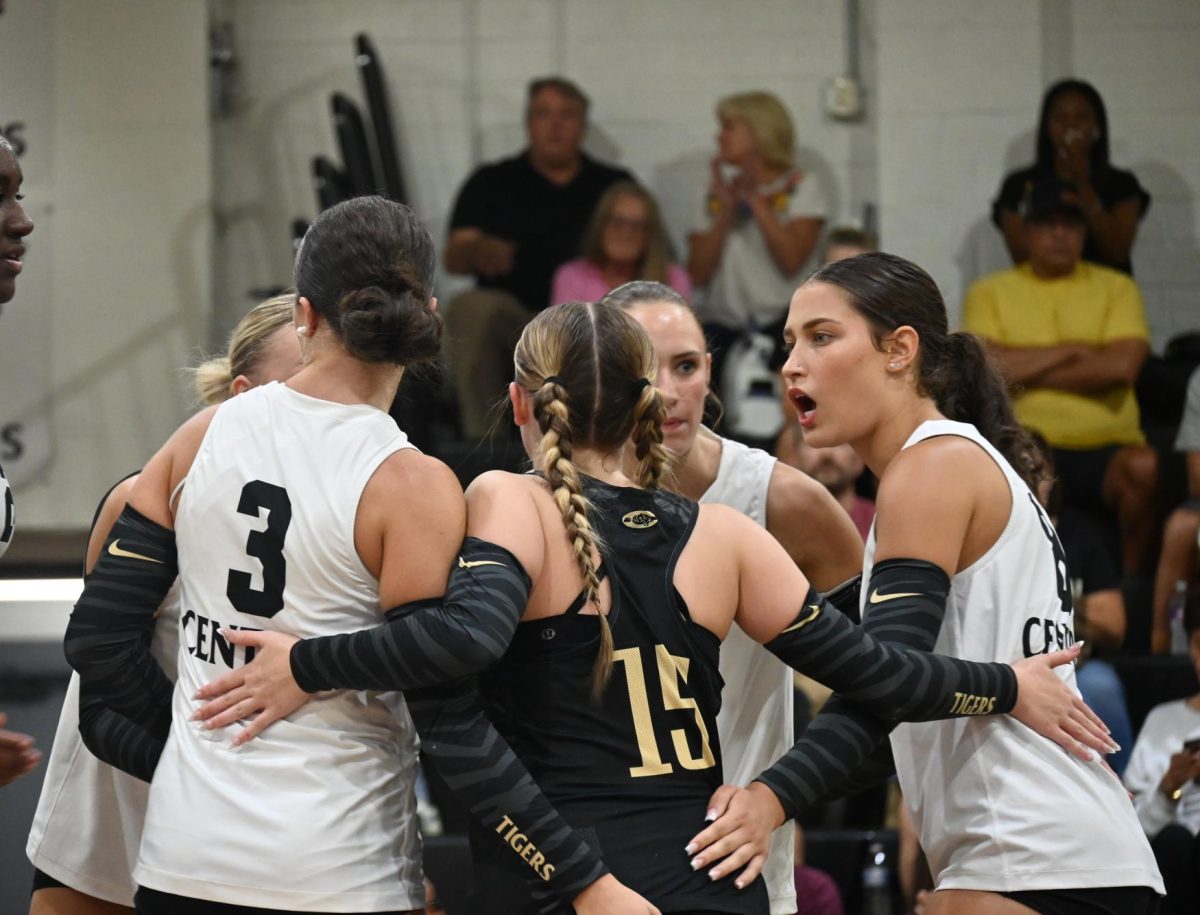 Captain Lydia Warrior (senior) gives a quick pep talk to the rest of her team on court after a set they played against Greenbriar Aug. 25.