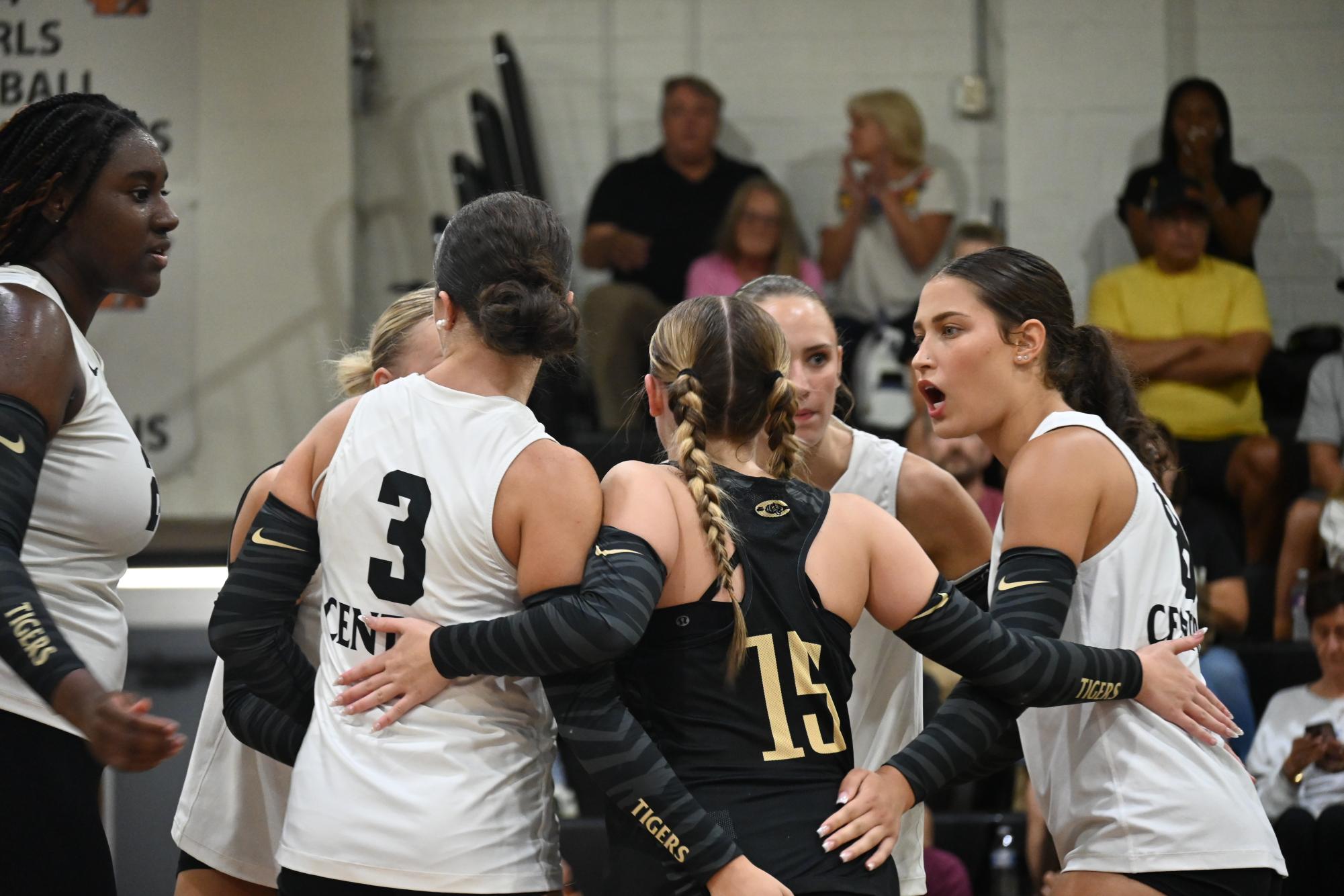 Captain Lydia Warrior (senior) gives a quick pep talk to the rest of her team on court after a set they played against Greenbriar Aug. 25.