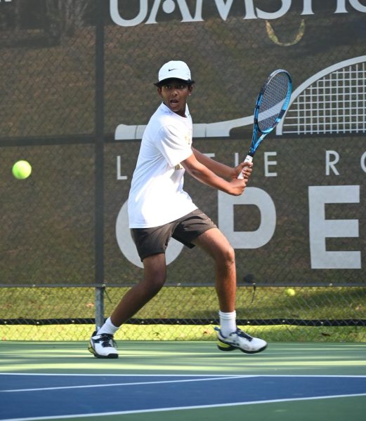Junior Ani Reddy prepares to serve against Catholic High Sept. 9. Reddy won his match, helping the team with an overall victory against Catholic.