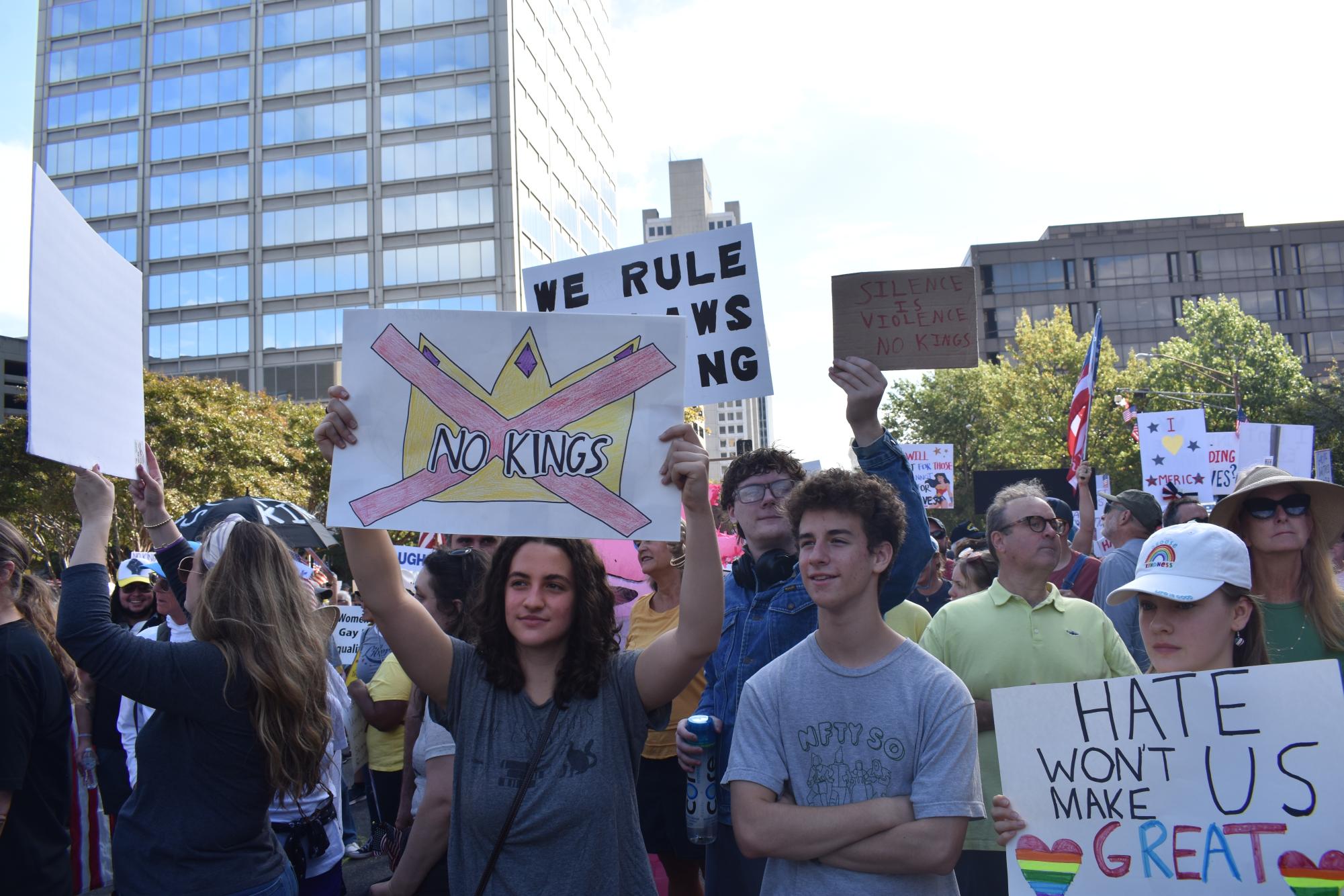 Mira Krain (senior), Milo Krain, and Amanda Weidauer (sophomores) take part protesting in front of the Federal Building with handmade signs Oct. 18.