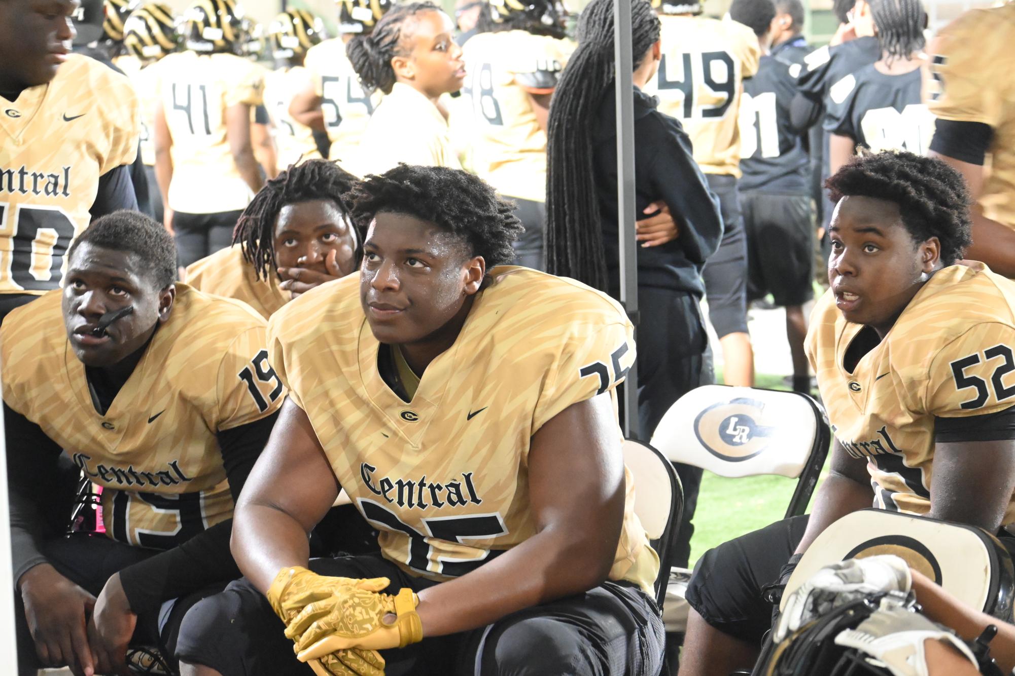 Players Kyle Williams, Messiah Farid, and Bryson Kennedy rewatch their plays in order to take the win against Springdale Aug. 29.