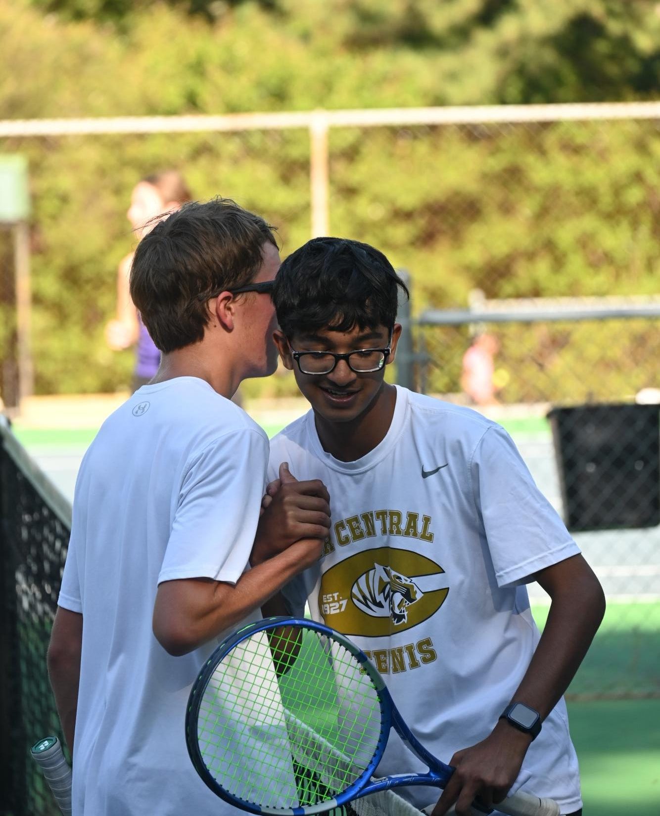 Sophomore Ayaan Patil shakes hands with Catholic opponent after a match. 