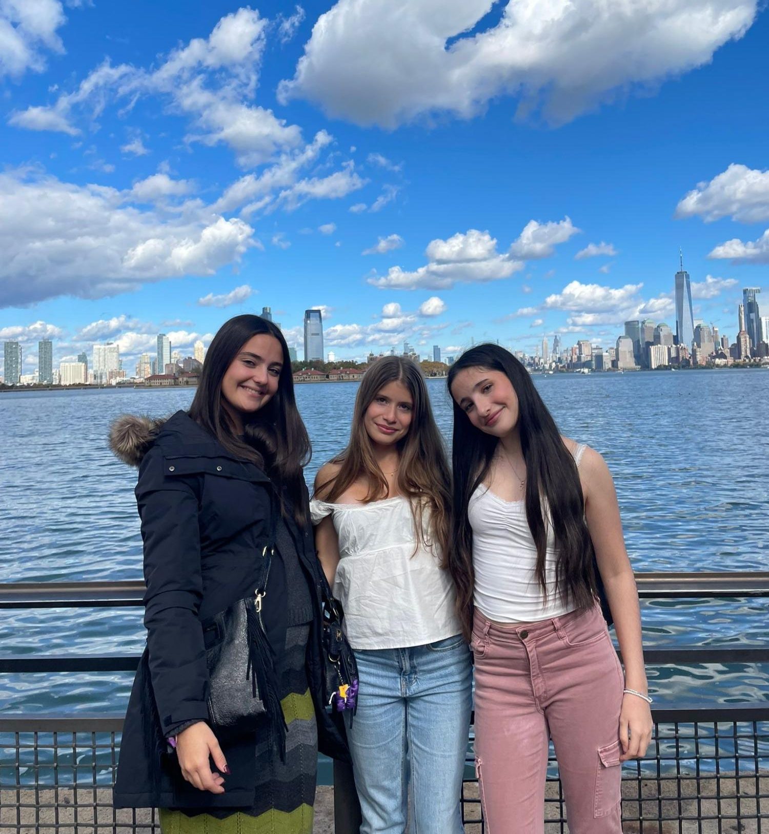 Ariane Bilbao, Paula Triasdebes, and Adriana Gellida pose in front of the Statue of Liberty during their sight-seeing ferry trip, Oct. 25.
